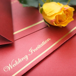 a wedding invitation, with a yellow rose